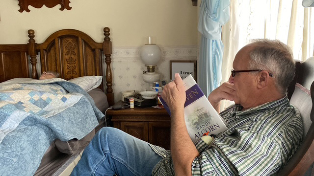 Jerry reading to his wife from the Heaven book